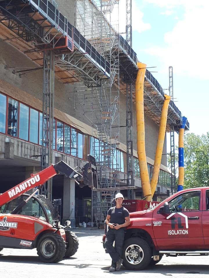 Chariot télescopique et camion FL devant une façade en chantier